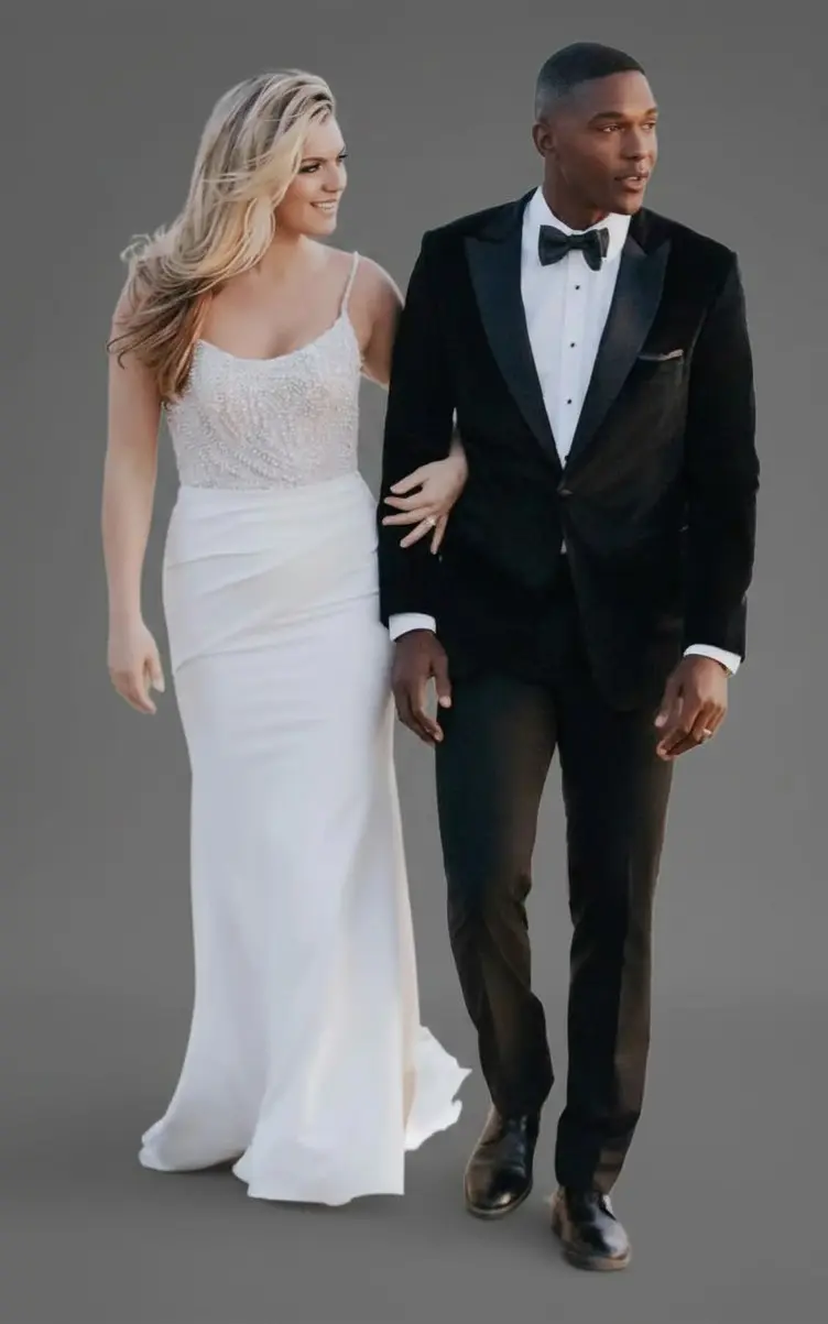 ovio con esmoquin negro de terciopelo y solapa peak junto a novia con vestido blanco, caminando tomados del brazo — Masculino.do